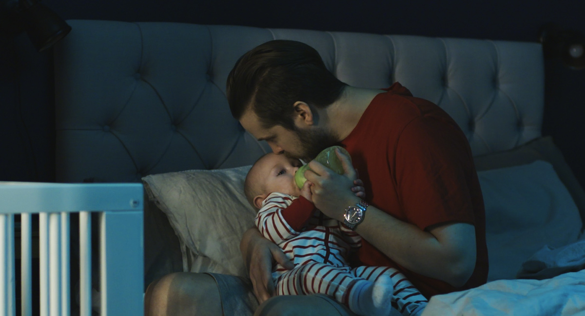 Banner father feeding baby