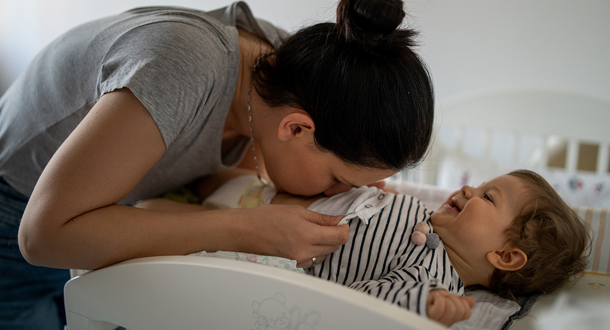 Banner woman kissing baby belly
