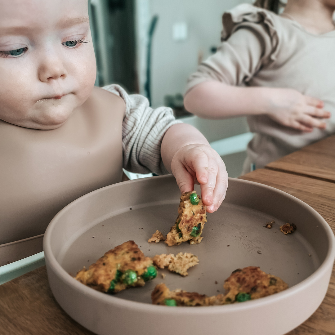 Banner baby eating finger food