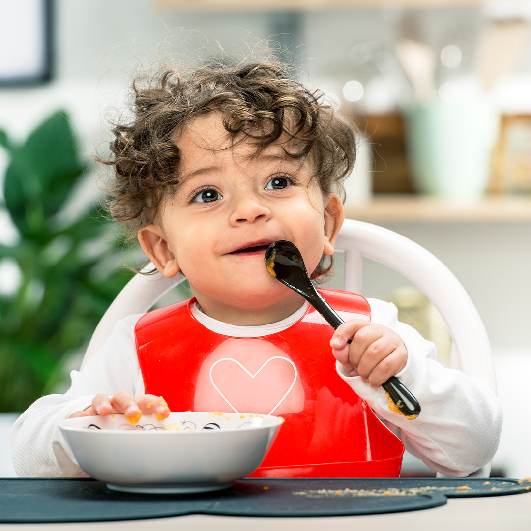Banner baby with bib eating