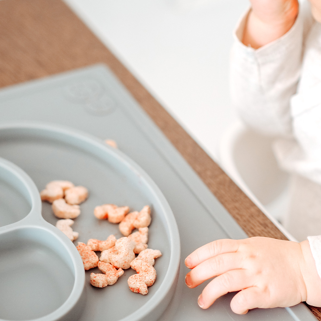 Baby eating Semper Multigrain Puffs